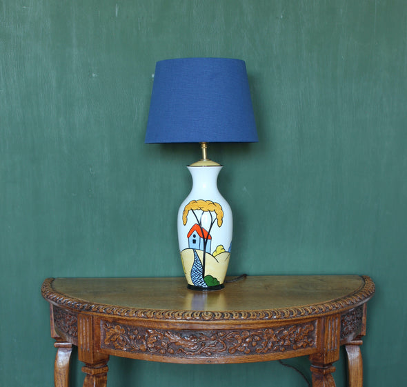 Brian Wood Ceramic Vase.  Uniquely graphic handmade ceramic lamp that draws the eye and attention immediately.  Great balance of colour and a superb shape.  All new fittings and braided flex.  Height = 480mm (not including shade or bulb)  Max Width = 130mm White yellow, red, blue and green colours and a blue shade.